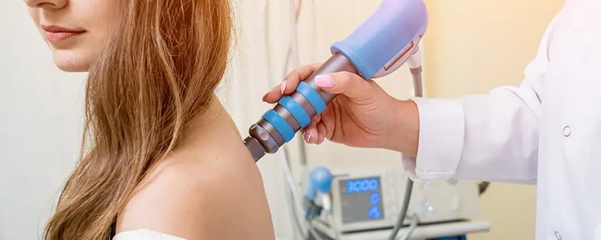 Class IV laser therapy device being applied to a patient's shoulder for pain treatment in Encinitas